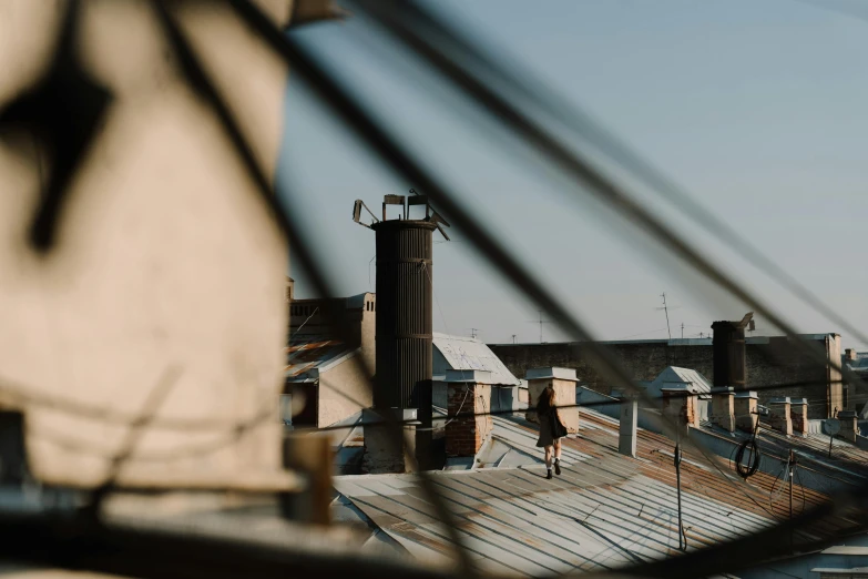 a couple of people standing on top of a roof, unsplash contest winner, visual art, brown, silo, low quality photo, alleys