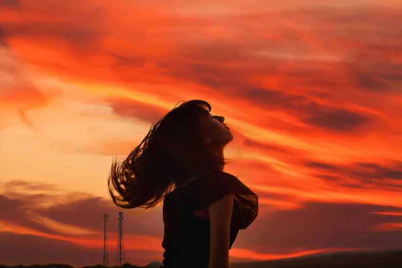 a woman with her hair blowing in the wind, pexels contest winner, romanticism, orange and red sky, instagram post, no cropping, beautiful backlit