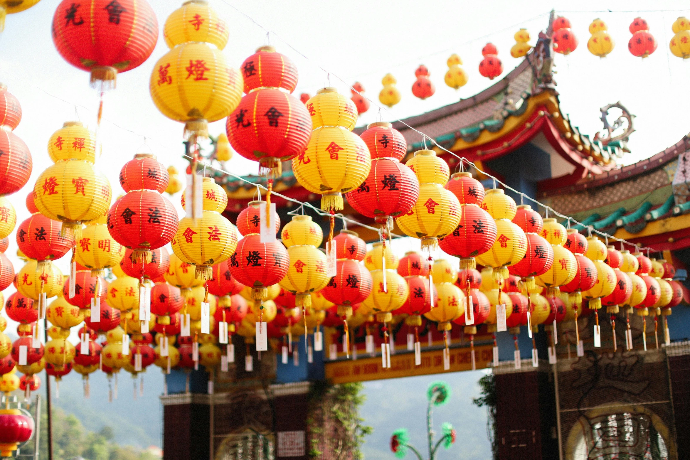 a bunch of red and yellow lanterns hanging from a ceiling, inspired by Ju Lian, pexels contest winner, pagodas on hills, 🦩🪐🐞👩🏻🦳, square, jen zee