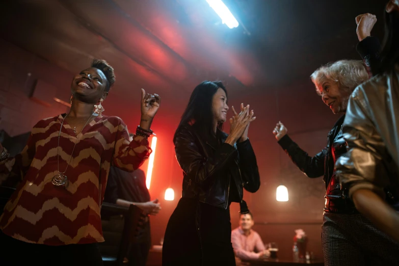 a group of people standing on top of a stage, an album cover, pexels, three women, diner scene, maggie cheung, lgbtq