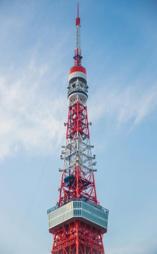 a tall red tower sitting on top of a lush green field, by Miyamoto, pexels, sōsaku hanga, radio equipment, square, akihabara, high quality image