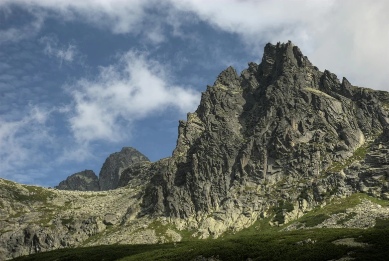 a group of people walking up the side of a mountain, by Adam Marczyński, pexels contest winner, les nabis, tall stone spires, summer landscape with mountain, фото девушка курит, 3/4 view from below