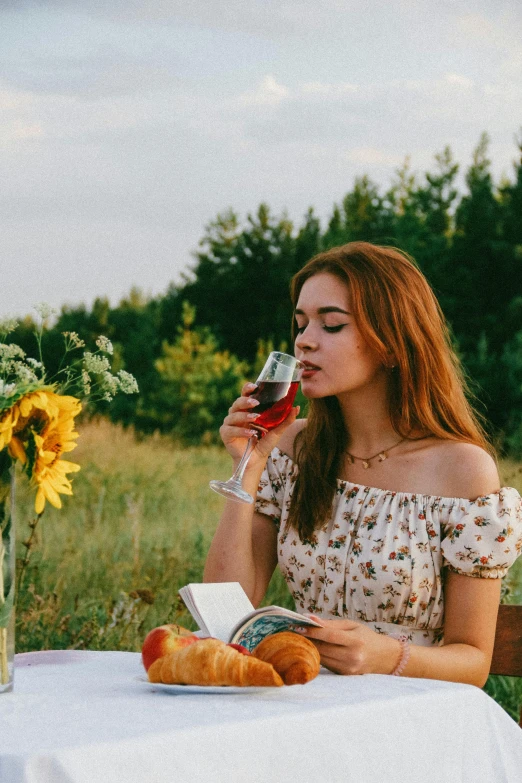 a woman sitting at a table with a glass of wine, pexels contest winner, sitting in a field, young southern woman, pleasing, woman with rose tinted glasses