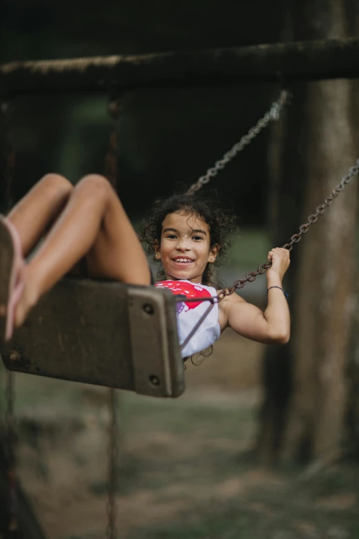 a little girl that is sitting on a swing, pexels contest winner, diverse ages, sturdy body, slides, textured