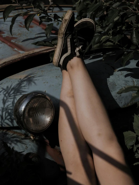 a close up of a person's legs on a car, a picture, inspired by Elsa Bleda, trending on pexels, vintage glow, olive thigh skin, bad light, ilustration