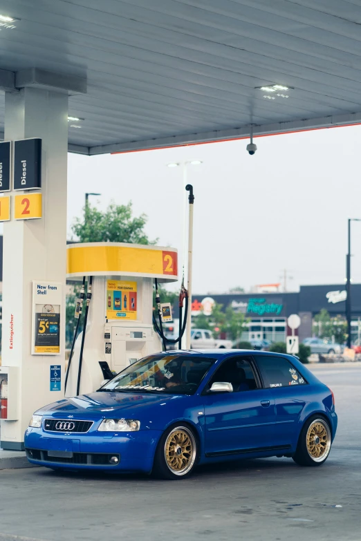 a blue car parked in front of a gas station, unsplash, hyperrealism, audi a4 b6 avant (2002), liquid gold, 2 5 6 x 2 5 6 pixels, professionally color graded