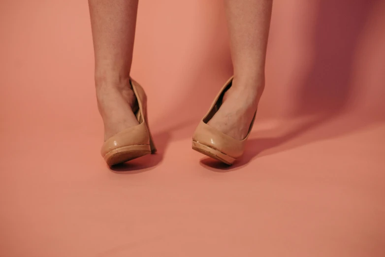 a woman's legs in high heels on a pink background, trending on pexels, hyperrealism, beige, shot on sony a 7 iii, brown, 15081959 21121991 01012000 4k