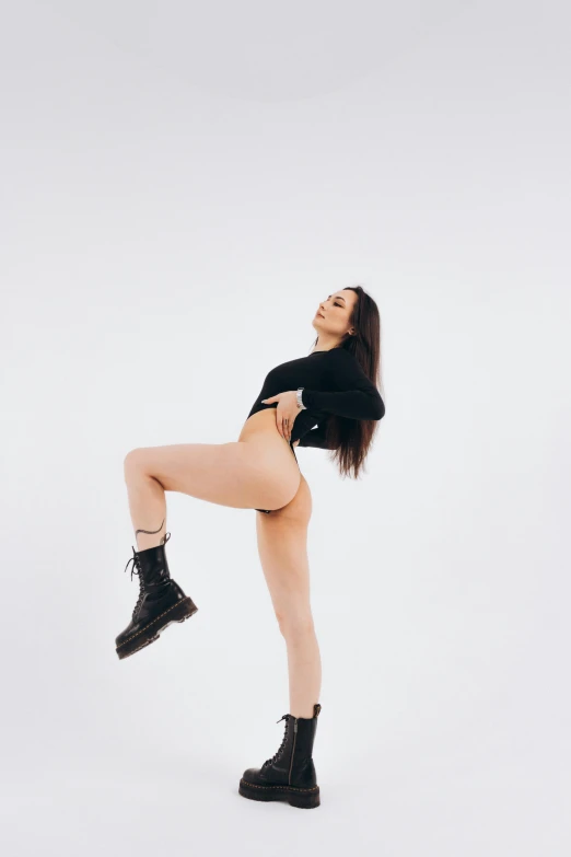 a woman in a black shirt and black boots, unsplash, arabesque, exposed thighs!!!, irelia, low quality photo, view(full body + zoomed out)