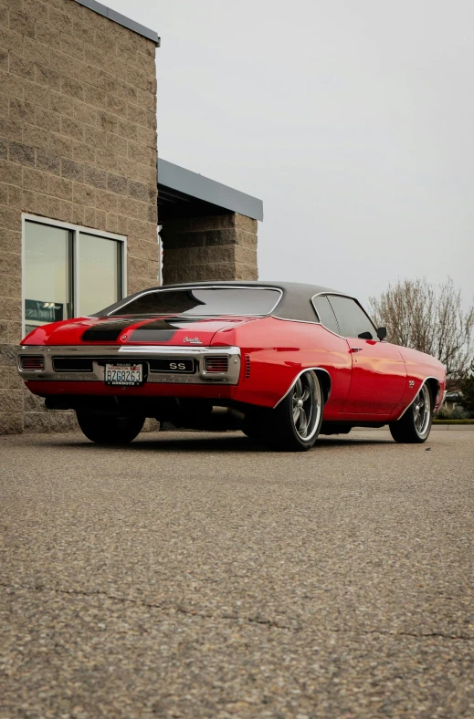 a red car parked in front of a brick building, profile image, lowriders, high quality photo, square