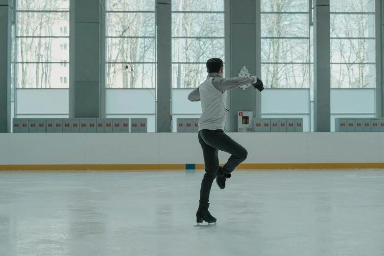 a man riding a skateboard on top of an ice rink, inspired by Fei Danxu, arabesque, **cinematic, thumbnail, pose 4 of 1 6, cinematic still frame