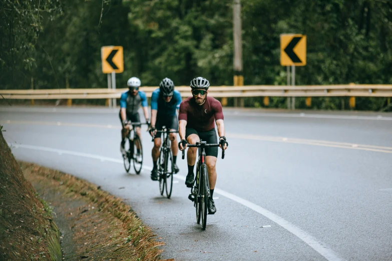 a group of bicyclists riding down a curvy road, pexels contest winner, three people running a marathon, avatar image, sydney hanson, in karuizawa