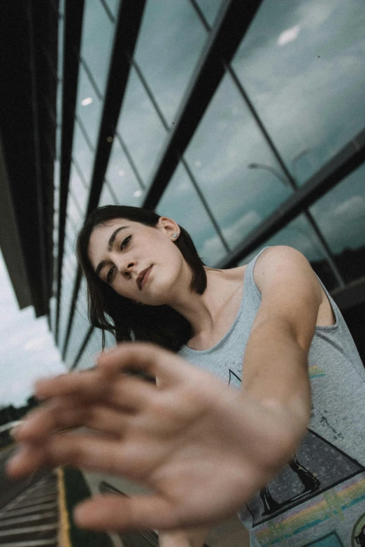 a woman that is standing in front of a building, by Tobias Stimmer, pexels contest winner, depressed dramatic bicep pose, selfie of a young woman, with fingers, indoor picture