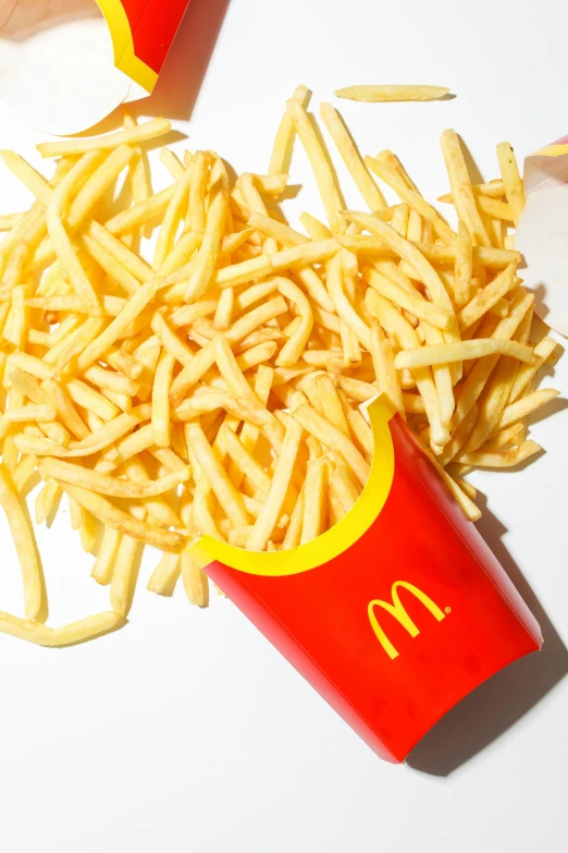 a pile of french fries sitting on top of a table, mcdonald, half image, best selling, medium detail