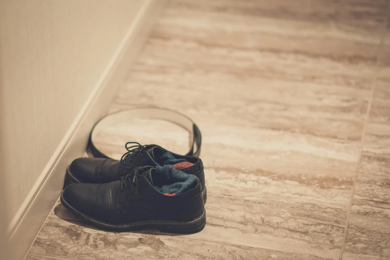 a pair of shoes sitting on the floor next to a mirror, pexels contest winner, black leather accents, ((sharp focus)), sleepers, ground broken