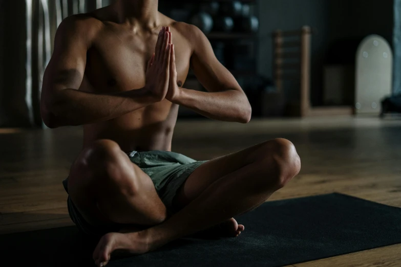 a man sitting in the middle of a yoga pose, unsplash, hurufiyya, realistic body, with fingers, local gym, leaked