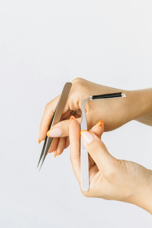 a woman cutting her nails with a pair of scissors, by Adam Marczyński, trending on pexels, photorealism, square jaw-line, multi-part, brushed, very minimal