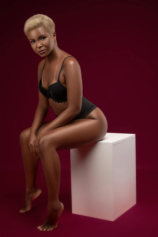 a woman sitting on top of a white cube, by Cosmo Alexander, pexels contest winner, sexy girl with dark complexion, curved. studio lighting, sitting on a mocha-colored table, black underwear