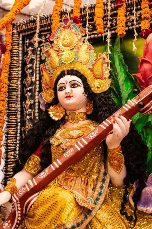 a statue of a woman playing a sitar, ornate mask and fabrics, religious imagery, slide show, worship