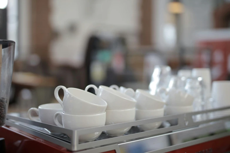 a row of coffee cups sitting on top of a counter, by Jessie Algie, bright white porcelain, aussie baristas, ready to eat, polished