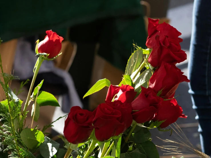 a bunch of red roses sitting on top of a table, slide show, up close