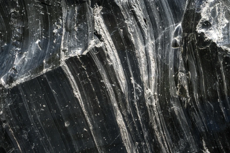 a close up of a rock with water coming out of it, inspired by Vija Celmins, unsplash, abstract expressionism, high detailed thin stalagmites, panel of black, alessio albi, black and silver