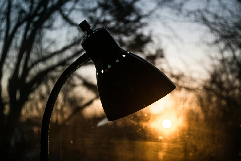 a lamp sitting on top of a table next to a window, by Jesper Knudsen, pexels contest winner, at sunrise in springtime, night outside, medium close-up shot, backlite