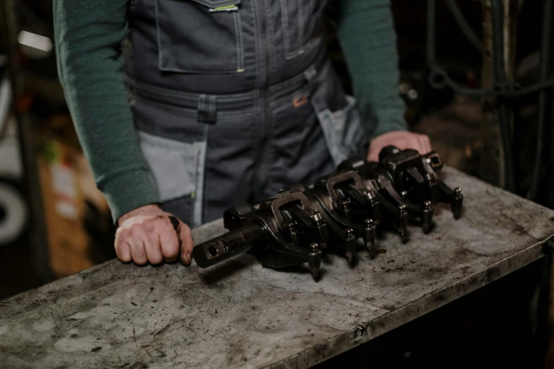 a close up of a person working on a machine, by Frederik Vermehren, auto-destructive art, pistons and bolts, 15081959 21121991 01012000 4k, press shot, holding a giant flail