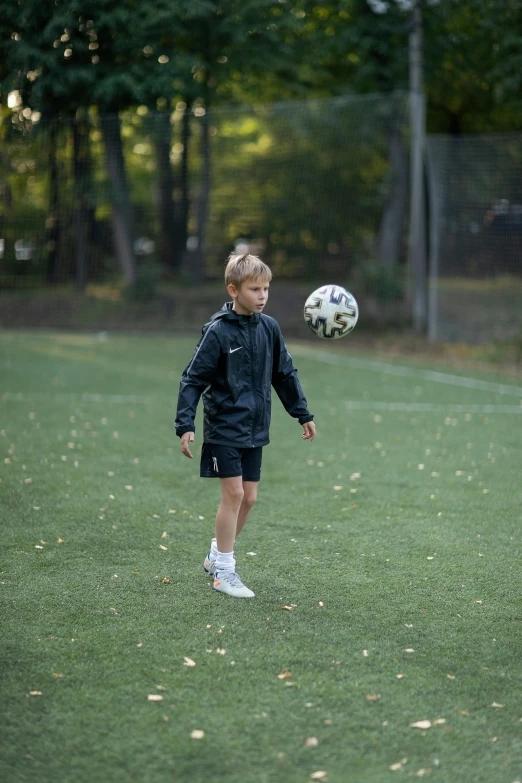 a little girl kicking a soccer ball on a field, inspired by Sergei Sviatchenko, dribble, 2019 trending photo, blond boy, 15081959 21121991 01012000 4k, small