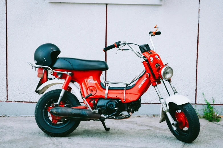 a red motorcycle parked in front of a building, pexels contest winner, orange and white color scheme, moped, avatar image, 70s photo