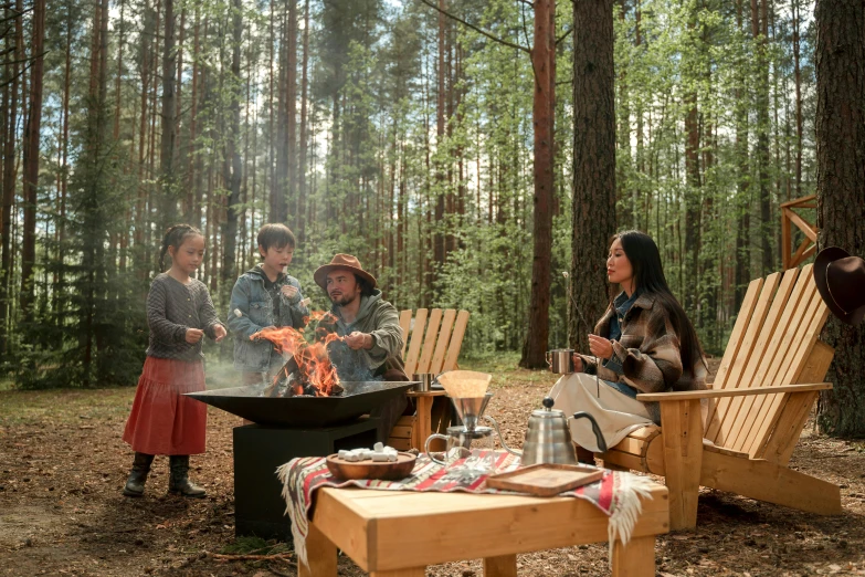 a group of people sitting around a fire pit, forest picnic, baba yaga, eero aarnio, fan favorite