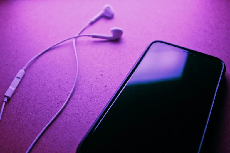 a cell phone sitting next to a pair of ear buds, trending on pexels, aestheticism, purple ambient light, thumbnail, pink and black, mid - shot