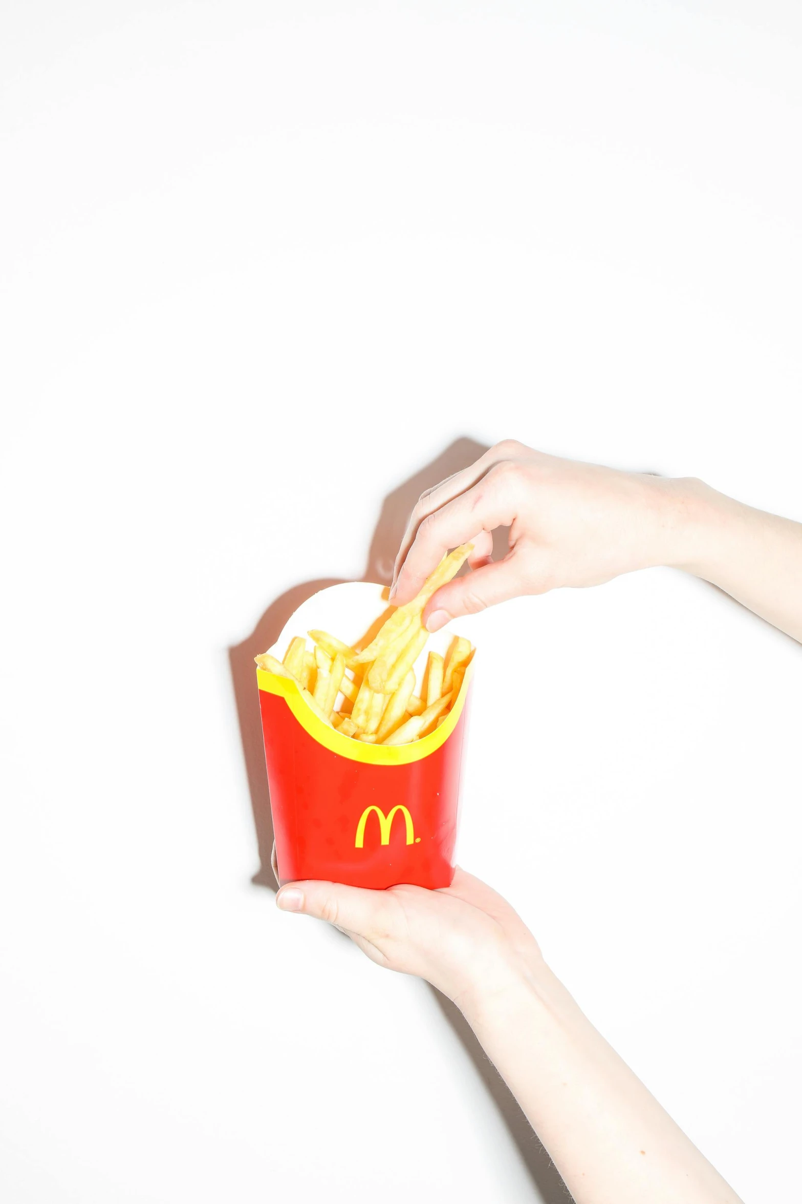 a person holding a box of french fries, unsplash, photorealism, mcdonald, on clear background, splash image, mac