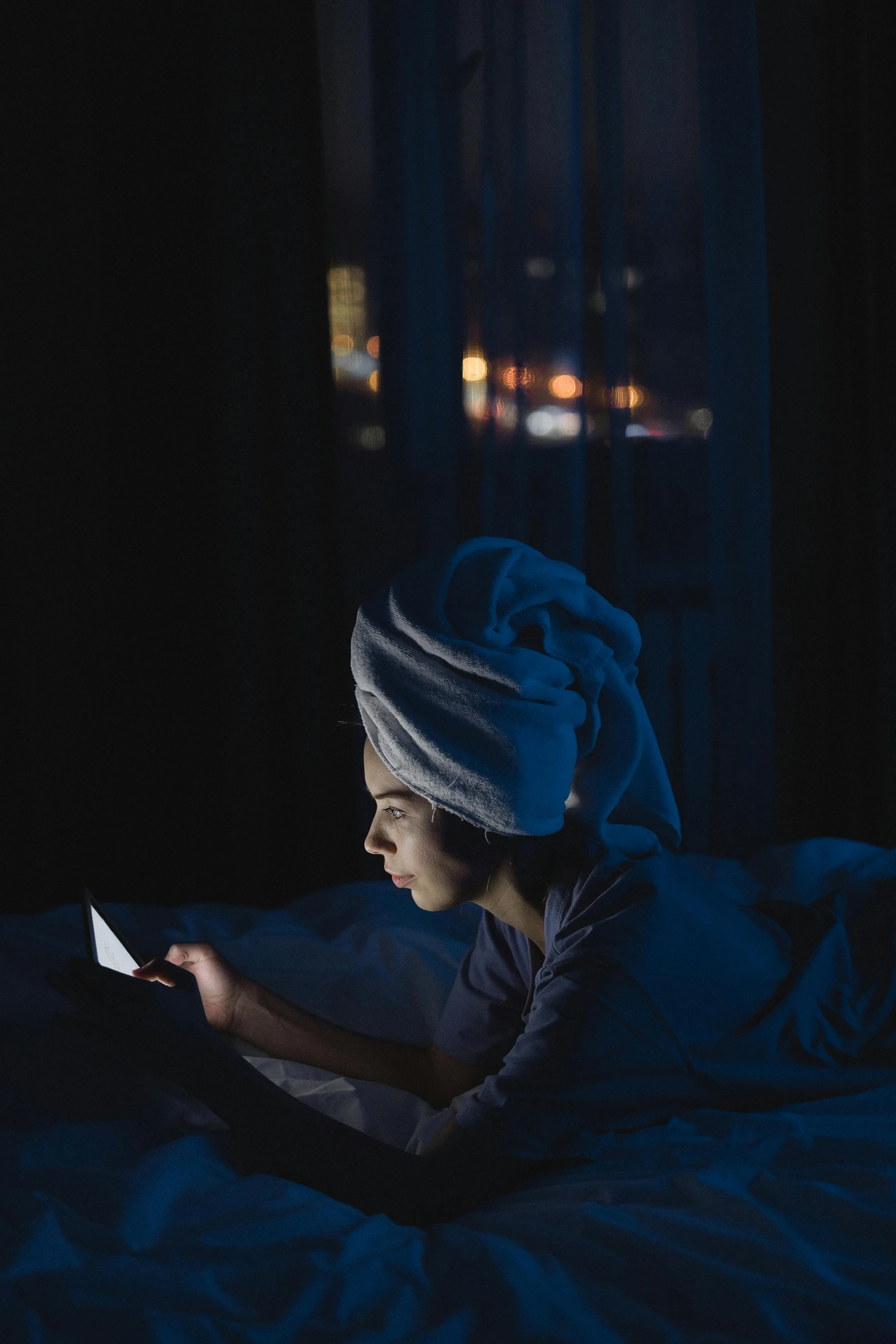 a woman laying in bed using a cell phone, inspired by Elsa Bleda, long night cap, profile image, reading, bedhead