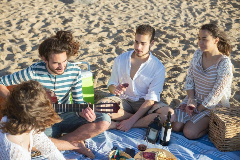 a group of people sitting on top of a beach, with a bottle of wine, ukulele, profile image, spanish