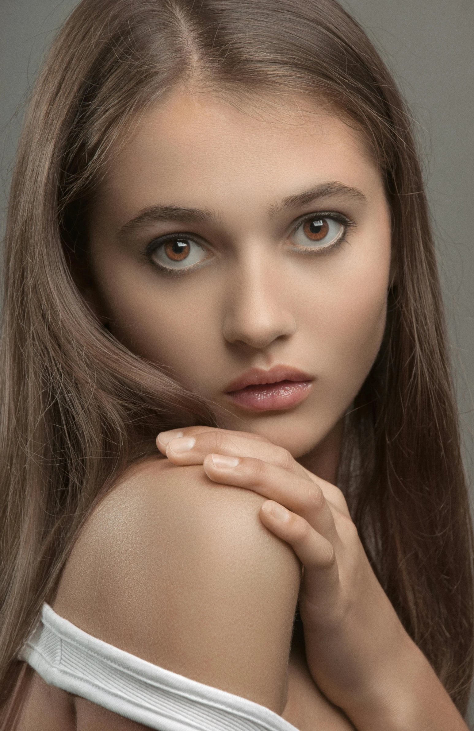 a woman with long brown hair posing for a picture, by irakli nadar, trending on pexels, photorealism, natural skin tone 4k textures, soft flawless pale skin, a beautiful teen-aged girl, wlop glossy skin