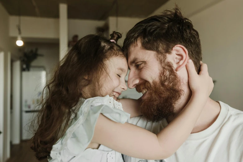 a man holding a little girl in his arms, pexels contest winner, reddish beard, avatar image, bedhead, smiling at each other