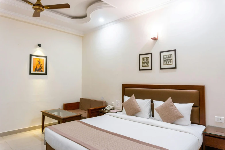 a bed room with a neatly made bed and a ceiling fan, unsplash, art nouveau, indore, hotel, fan favorite, in majestic