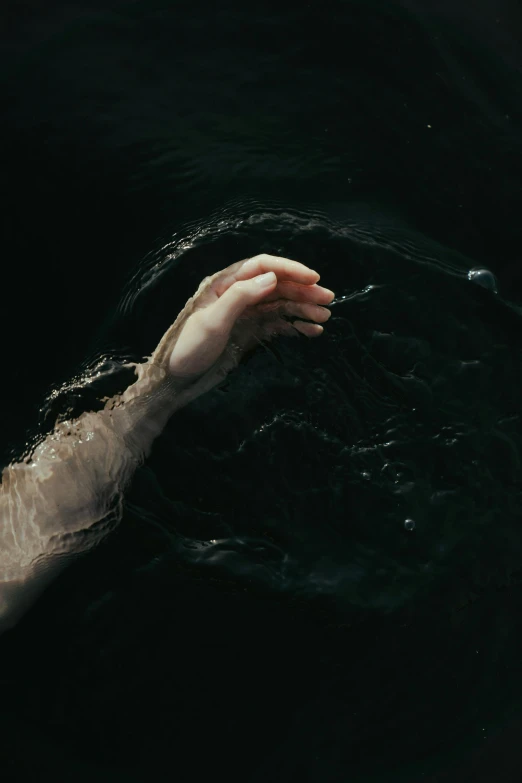 a person swimming in a body of water, an album cover, inspired by Elsa Bleda, unsplash, symbolism, hands of men, black water, ignant, ash thorp