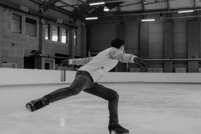 a man riding a skateboard on top of an ice rink, a black and white photo, pexels contest winner, arabesque, indoor picture, a handsome, animation, back arched