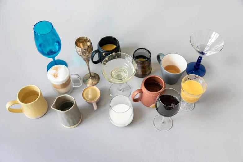 a bunch of cups sitting on top of a table, various refining methods, large glasses, full product shot, creamy