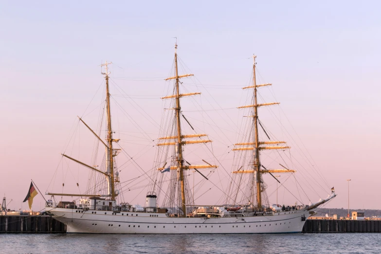 a large white boat floating on top of a body of water, by Johan Lundbye, pexels contest winner, romanticism, three masts, pink, port, anato finnstark. front view