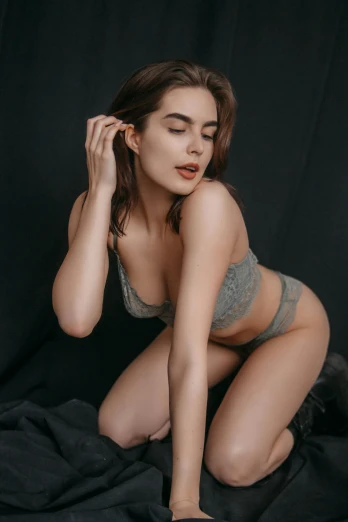 a woman sitting on top of a black blanket, a colorized photo, inspired by Elsa Bleda, reddit, 🤤 girl portrait, sexy outfit, grey backdrop, lingeries beauty