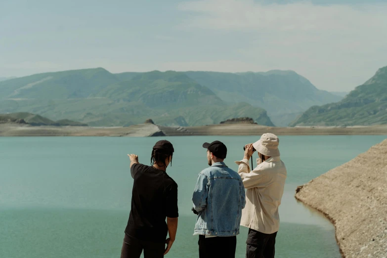 a group of people standing next to a body of water, by Muggur, visual art, filmic lut, mountain lake, water reservoir, music video