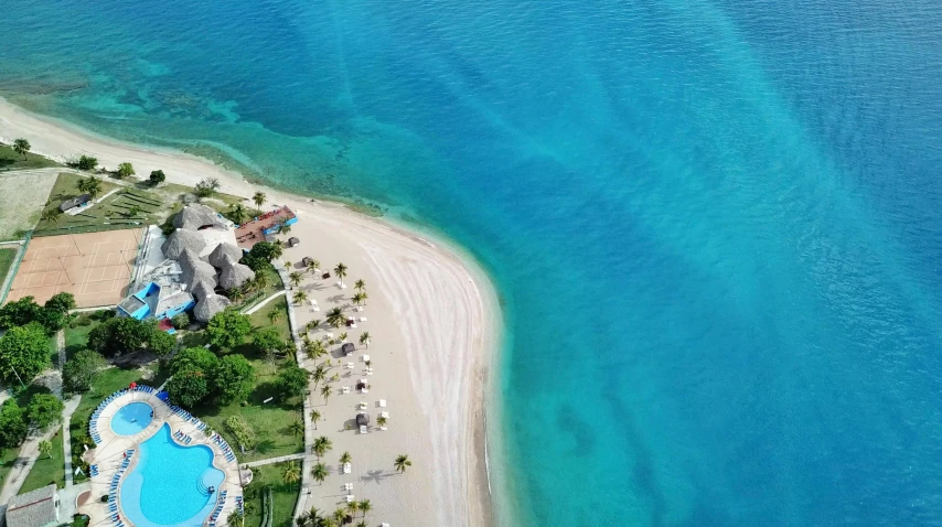 an aerial view of a resort in the middle of the ocean, by Robbie Trevino, pexels contest winner, fine art, carribean turquoise water, laying on a beach, 1 5 9 5, slide show