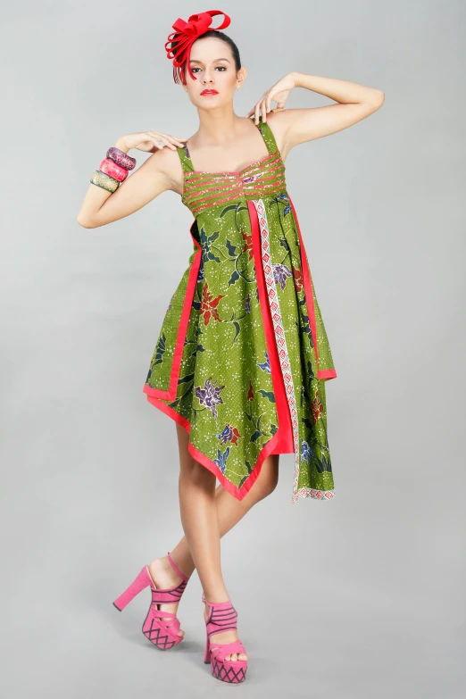 a woman in a green dress posing for a picture, inspired by Tang Di, happening, green and pink fabric, asymmetrical!!, official product photo, batik