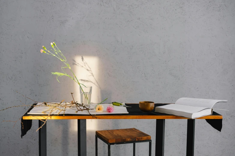 a wooden table topped with a vase filled with flowers, a photorealistic painting, inspired by Wang Wei, trending on pexels, minimalism, sumi - e lighting style, minimalist desk, light from right, morning atmosphere
