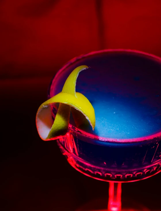 a blue cocktail sitting on top of a red table, neon yellow glowing mushrooms, the banana blue gang, plasma globe, skewed shot