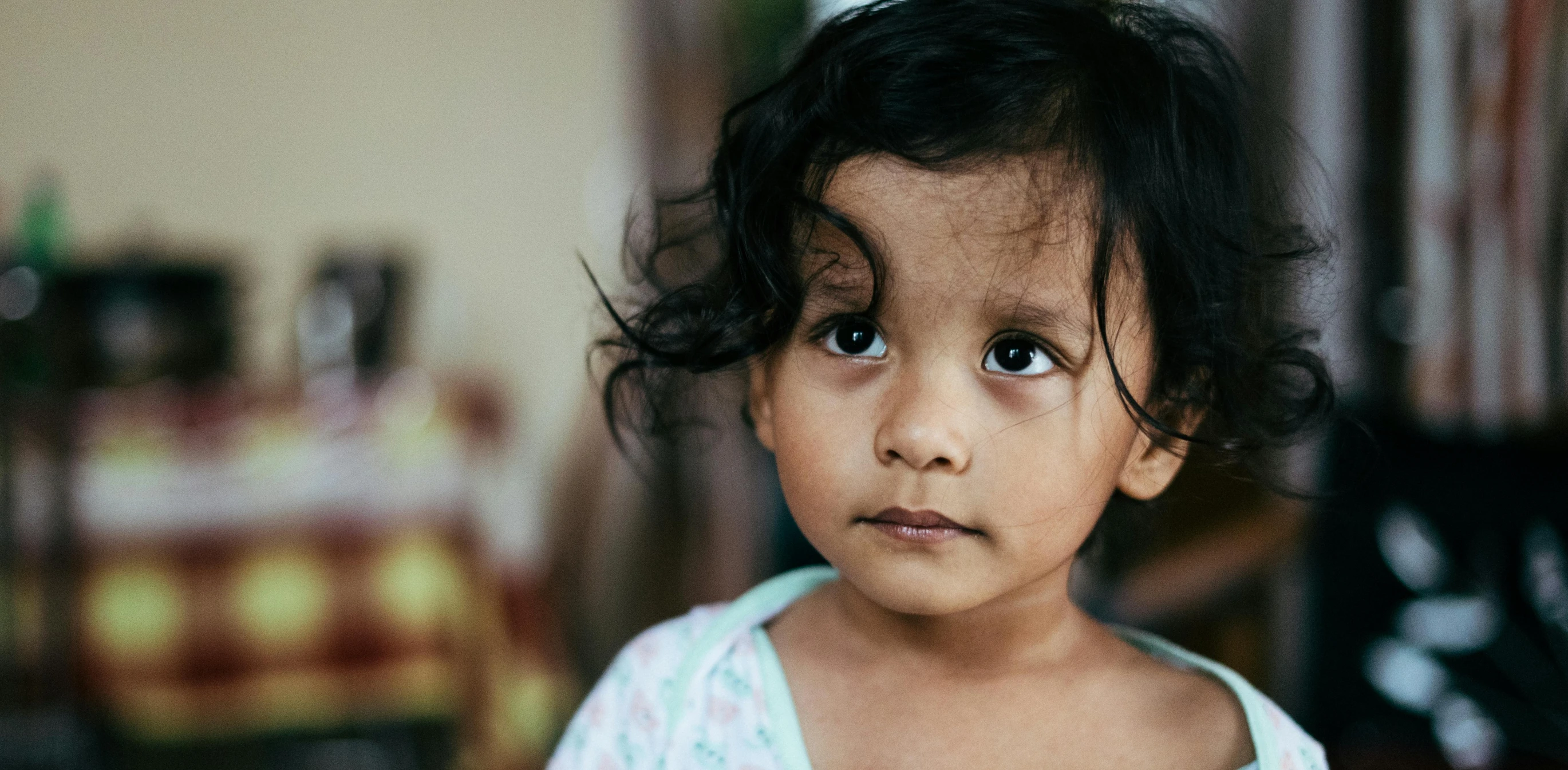 a close up of a child looking at the camera, pexels contest winner, hurufiyya, messy black hair, south east asian with long, tiny girl looking on, toddler