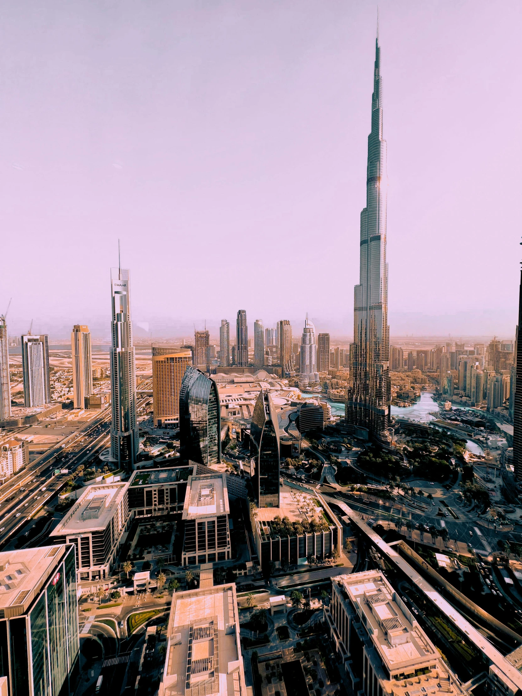 a view of a city from the top of a building, dubai, official screenshot, towering over your view, tall spires