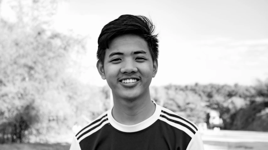 a black and white photo of a young man, inspired by Reuben Tam, soccer player, friendly smile, professional profile picture, naranbaatar ganbold